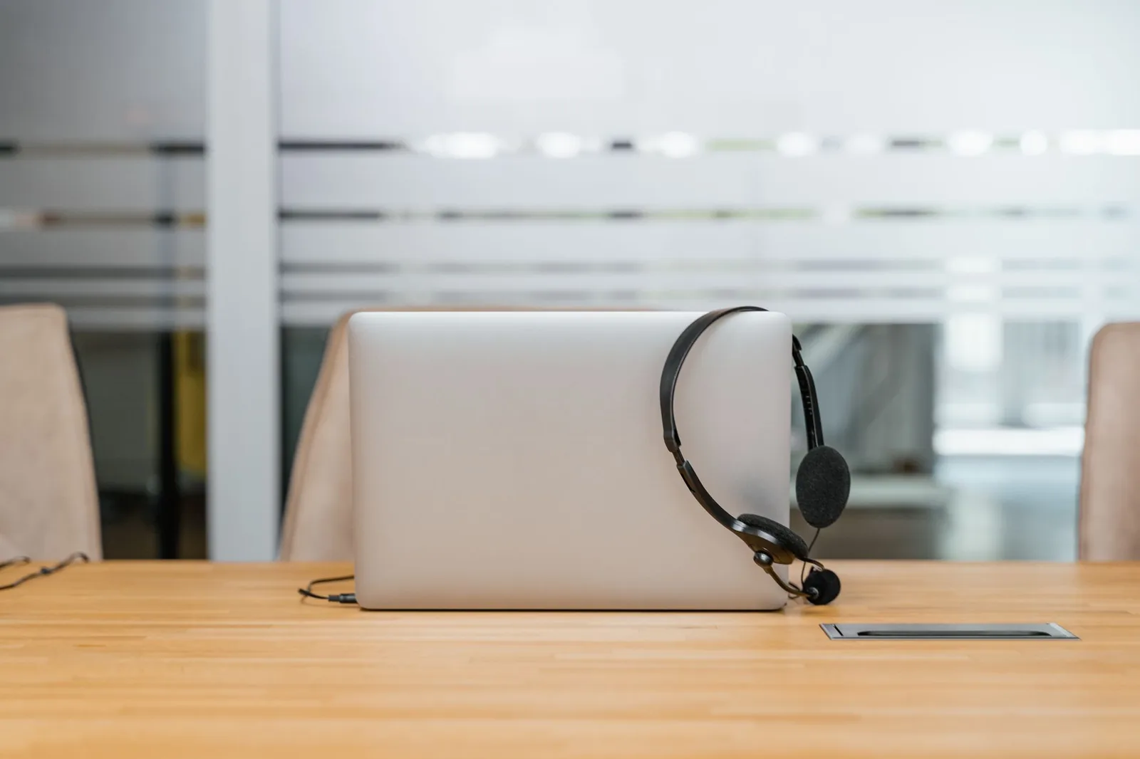 Headset auf Laptop als Hinweis auf externe Mikrofone, Anschlüsse und Videokonferenzen
