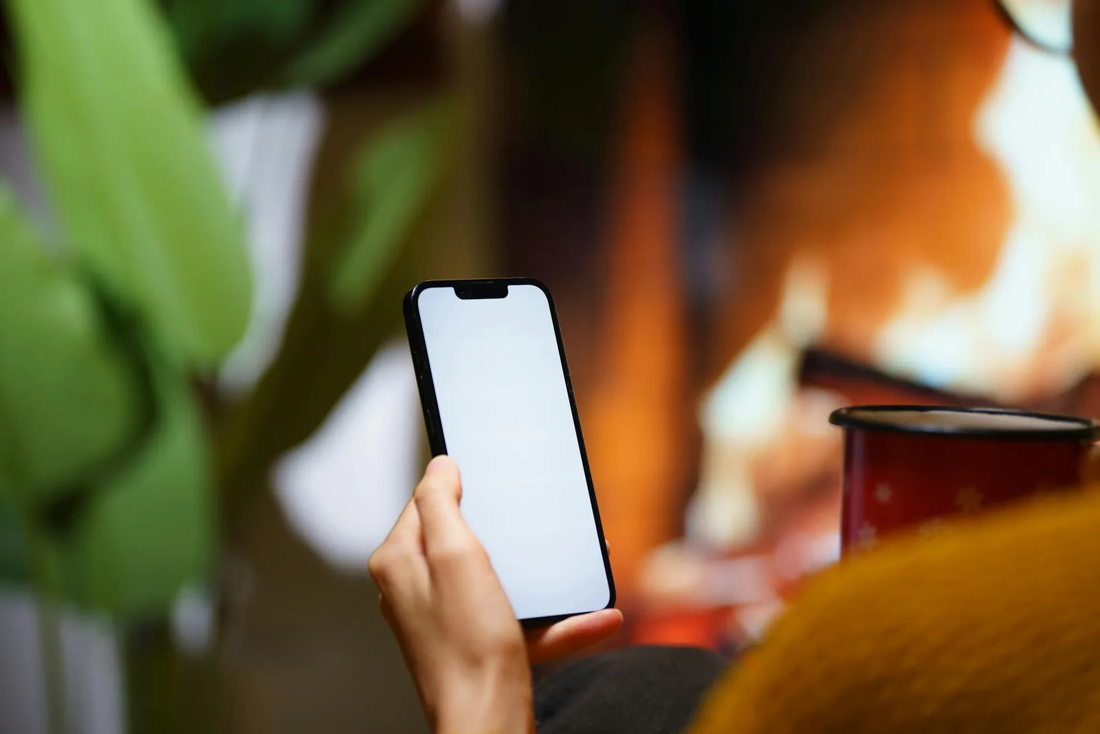 Smartphone vor wohnlicher Szene als Symbol für App-Steuerung und Temperaturkomfort